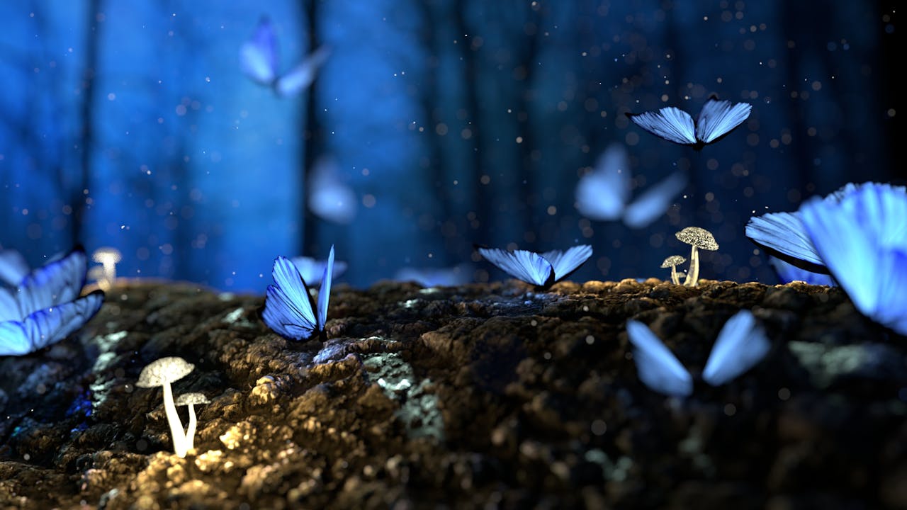 Blue butterflies with a glow around them land on a log covered in small white mushrooms with long stems. In the background, hazy silhouettes of trees against a blue backdrop.